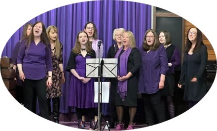 Group of our ladies singing on stage in Glasgow