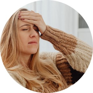 Menopausal woman holding a hand to her head