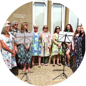 A group of our ladies singing at the Strawberry Tea Event in Giffnock, Glasgow