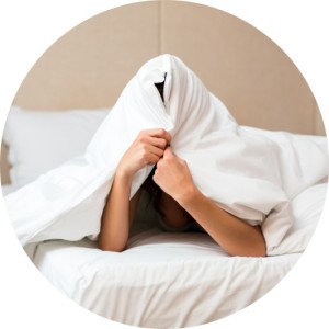 Woman hiding herself under a sheet