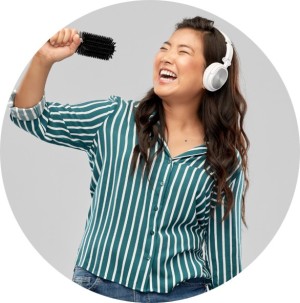 Woman singing into a hairbrush