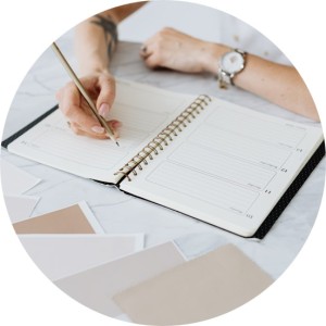 Woman writing goals in her diary